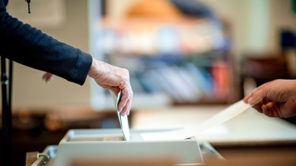 Foto: Eine Frau wirft ihren Stimmzettel in ein Wahlurne