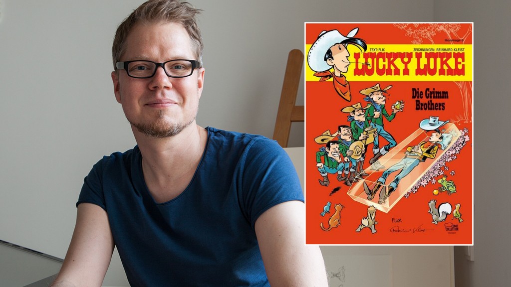 Comiczeichner Flix, daneben das neue Lucky-Luke-Heft von ihm